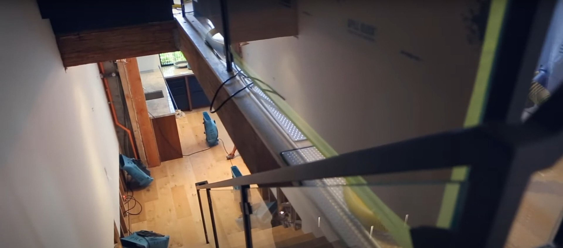 Professional structural drying setup showing water damaged area with industrial air movers and dehumidification equipment in Johns Creek property