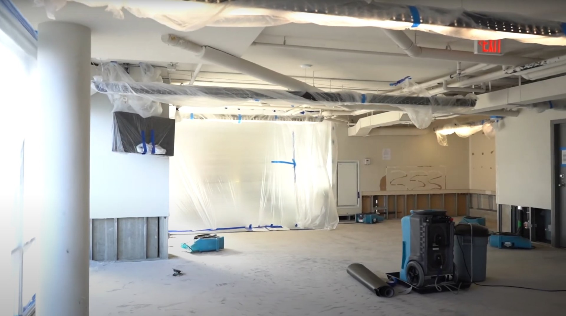 Large commercial water damage restoration site with professional drying equipment and containment barriers in Johns Creek facility
