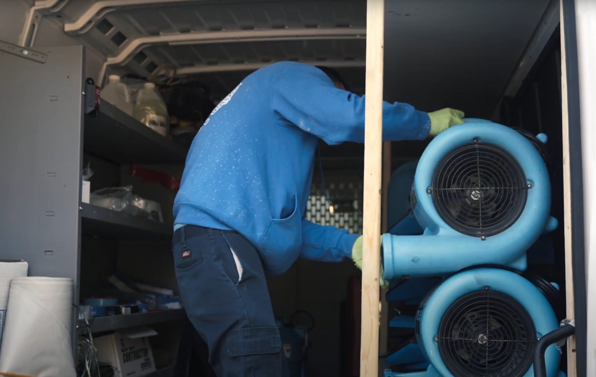 Professional water damage restoration technician using industrial equipment for emergency water extraction in Johns Creek home