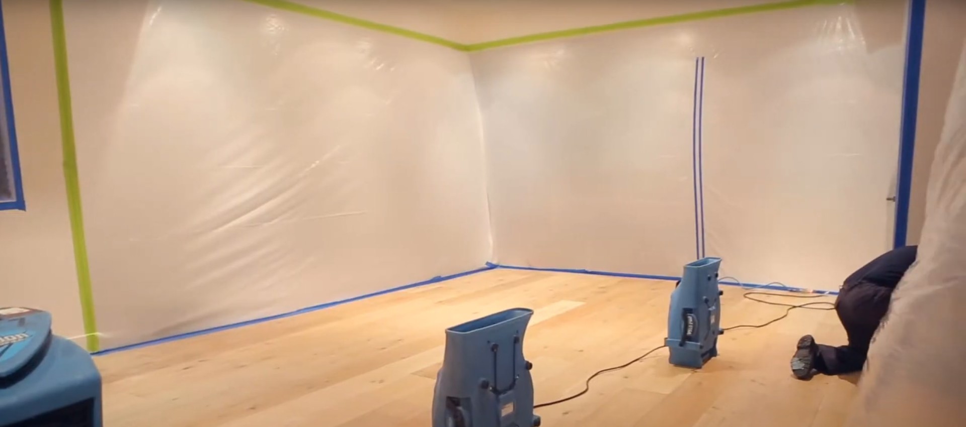 Professional water damage restoration room with industrial drying equipment and air movers set up for structural drying in Johns Creek home