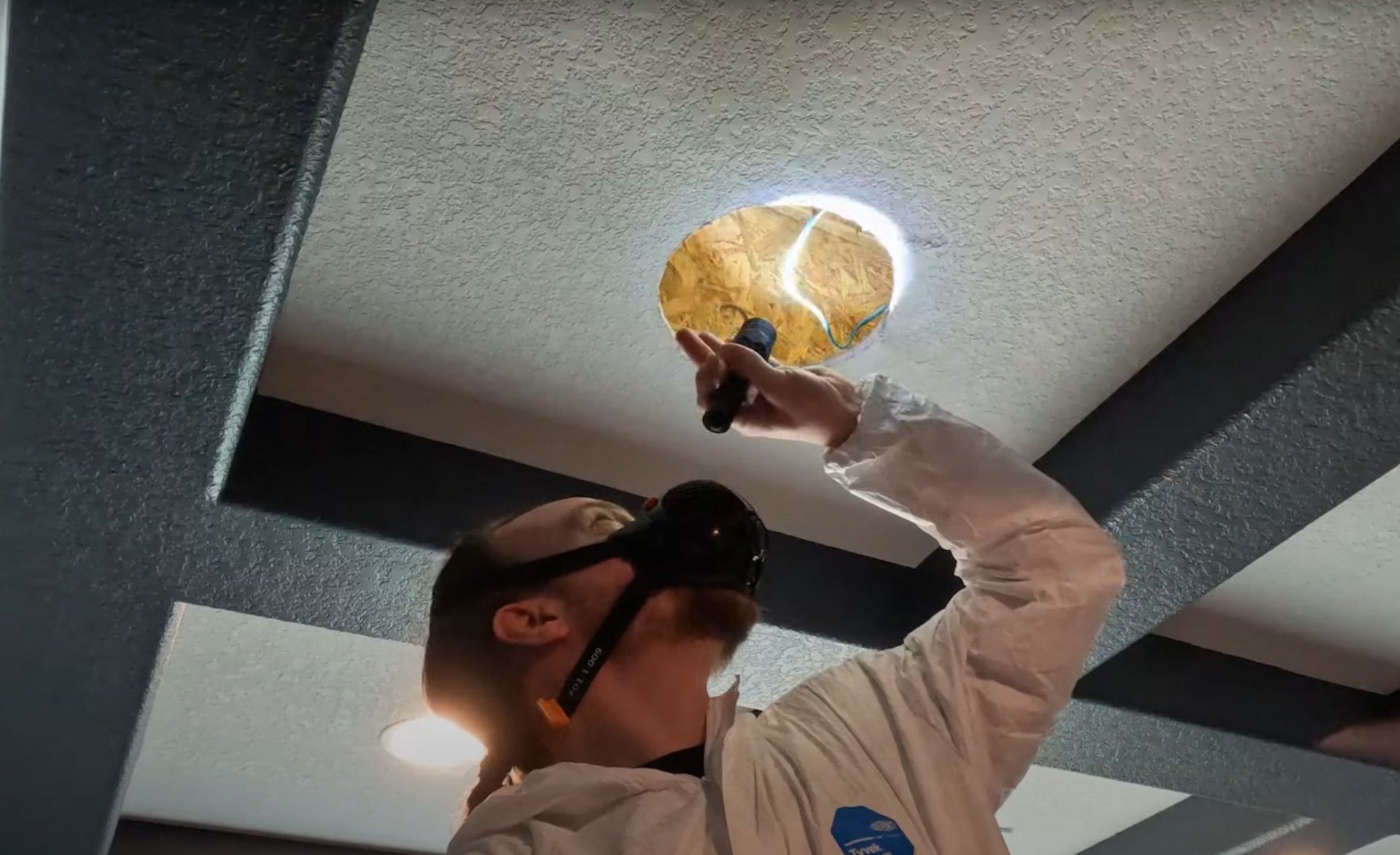 Professional mold remediation specialist using specialized equipment to inspect and test for mold growth in Johns Creek property ceiling